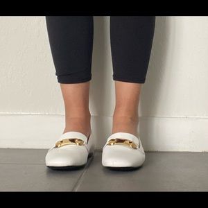 White Burberry flat shoes.